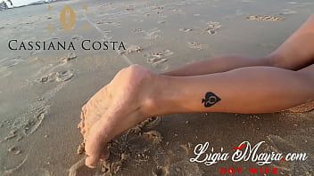 play Ze staat zonder beha op het strand in het hete zand